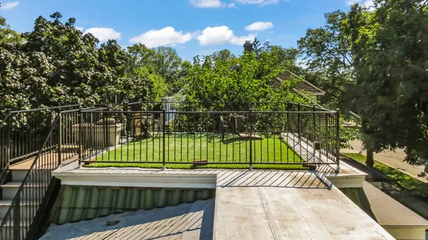 a view of swimming pool with a small deck and a garden