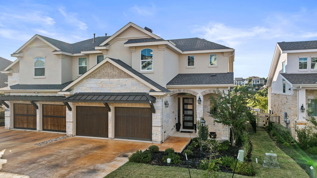 427 Cartwheel Bend, Unit 92 Austin, TX 78738 - Photo 1 of 40 a front view of a house with a yard and garage