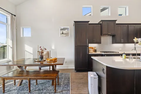 a kitchen with wooden cabinets and refrigerator