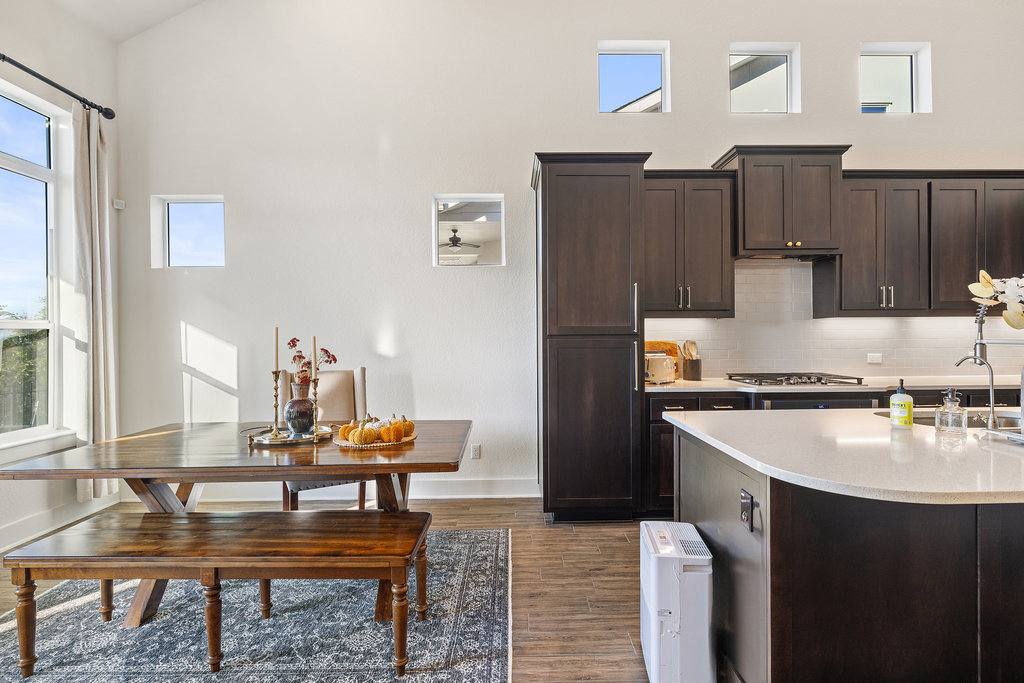 427 Cartwheel Bend, Unit 92 Austin, TX 78738 - Photo 17 of 40 a kitchen with wooden cabinets and refrigerator