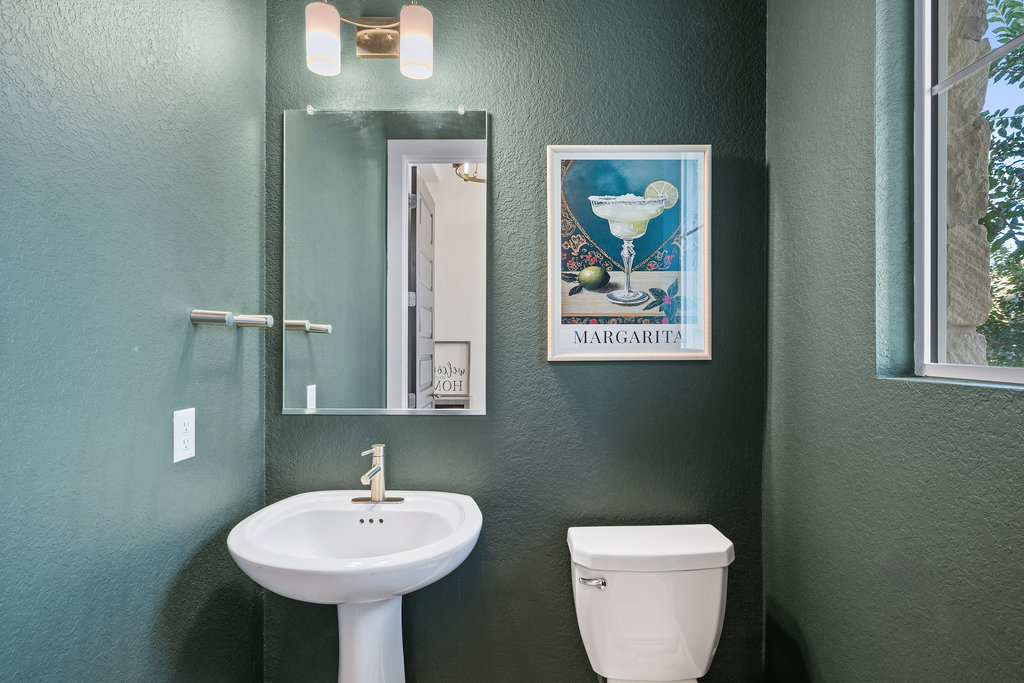 427 Cartwheel Bend, Unit 92 Austin, TX 78738 - Photo 19 of 40 a bathroom with a toilet a sink and mirror