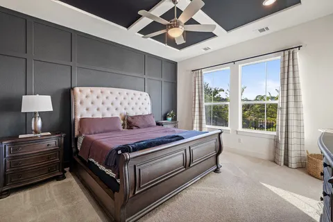 a bedroom with a bed and a large window