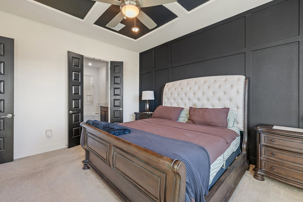 427 Cartwheel Bend, Unit 92 Austin, TX 78738 - Photo 23 of 40 a bedroom with a bed and a chandelier
