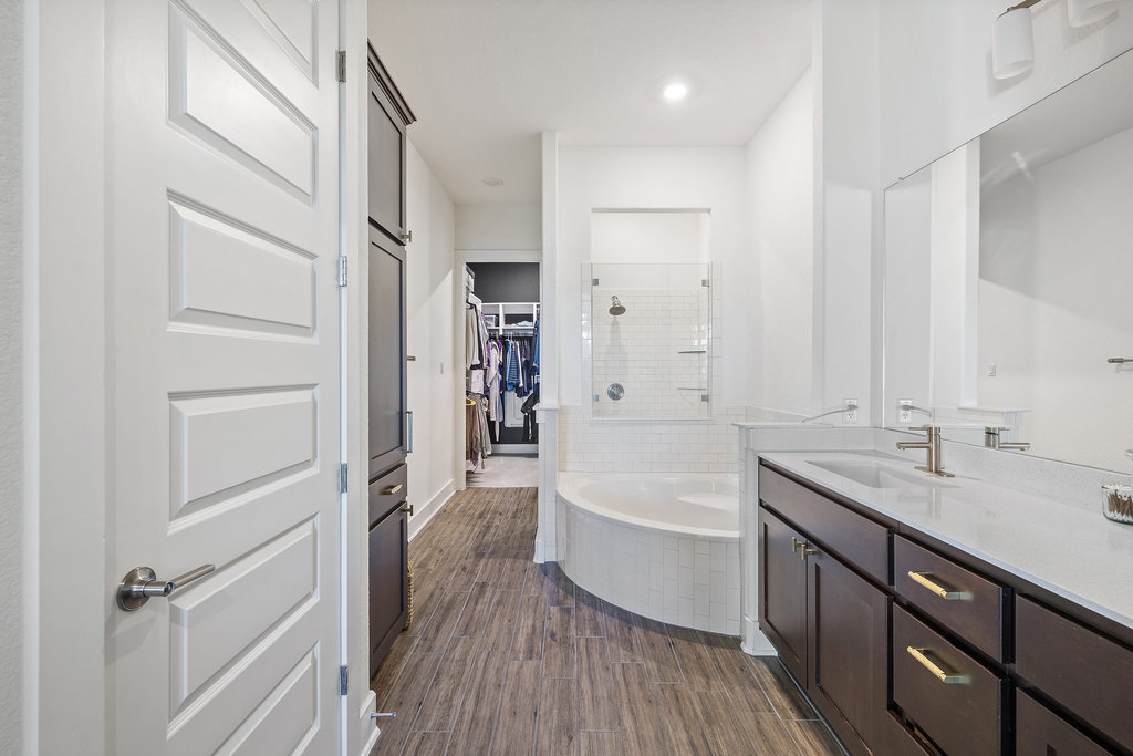 427 Cartwheel Bend, Unit 92 Austin, TX 78738 - Photo 24 of 40 a bathroom with a tub sink and mirror