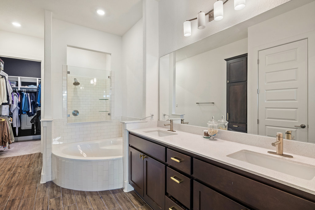 427 Cartwheel Bend, Unit 92 Austin, TX 78738 - Photo 25 of 40 a bathroom with a tub double sink and a mirror