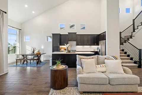 a living room with furniture and wooden floor