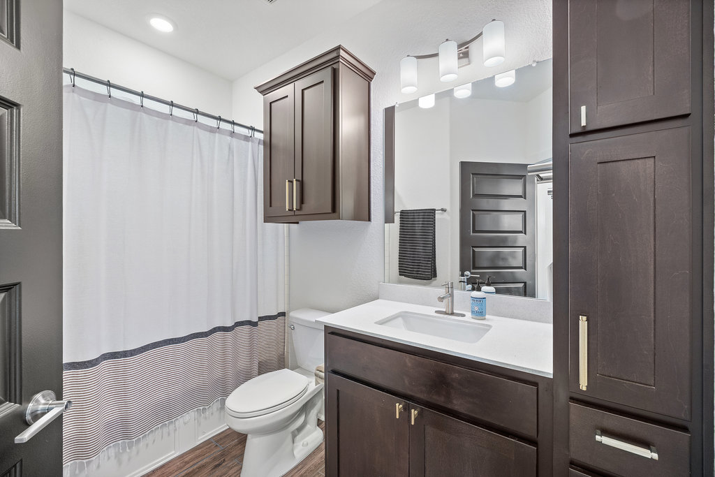 427 Cartwheel Bend, Unit 92 Austin, TX 78738 - Photo 29 of 40 a bathroom with a sink a toilet a mirror and shower