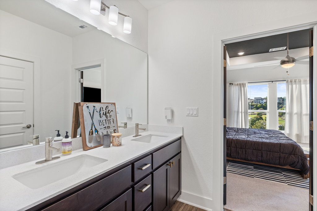 427 Cartwheel Bend, Unit 92 Austin, TX 78738 - Photo 30 of 40 a en suite bathroom with a double vanity sink and a mirror