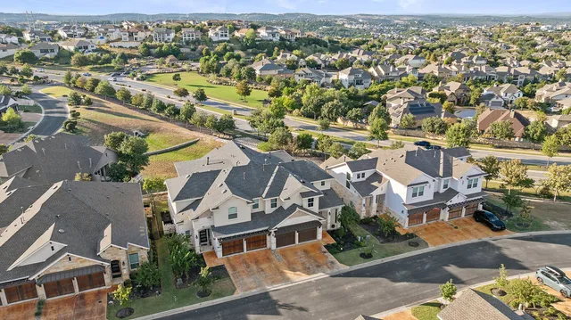 an aerial view of a house with a swimming pool