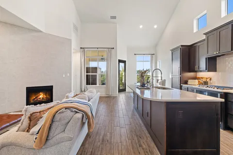 a kitchen with stainless steel appliances granite countertop a sink a stove and a refrigerator