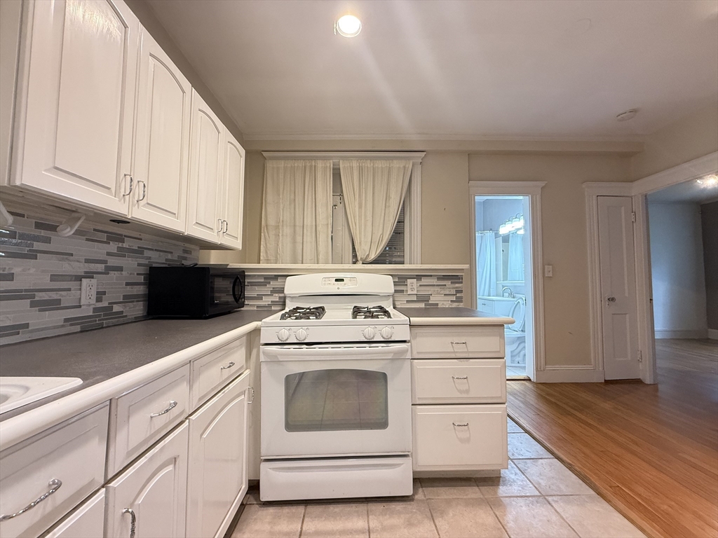 15 Colliston Road, Unit 5 Boston, MA 02135 - Photo 2 of 9 a kitchen with white cabinets and white appliances