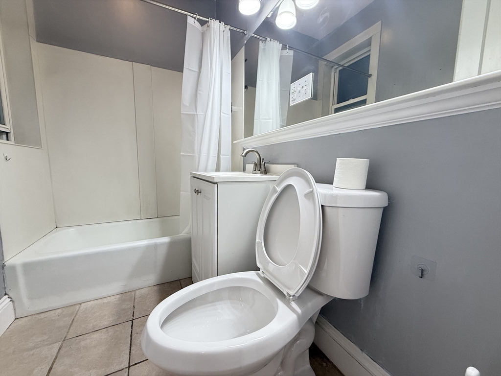 15 Colliston Road, Unit 5 Boston, MA 02135 - Photo 6 of 9 a white toilet sitting next to a bathroom sink