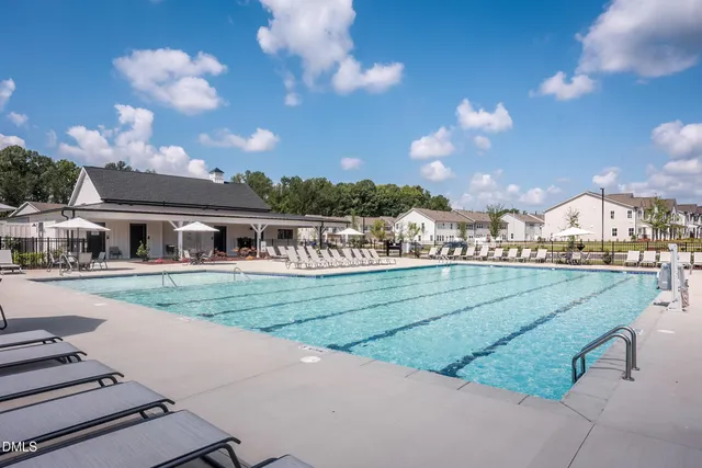 a view of a swimming pool and lounge chairs