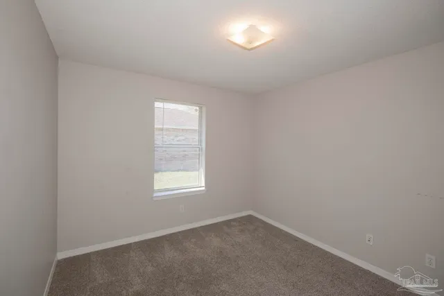 a kitchen with stainless steel appliances a white stove top oven and white cabinets
