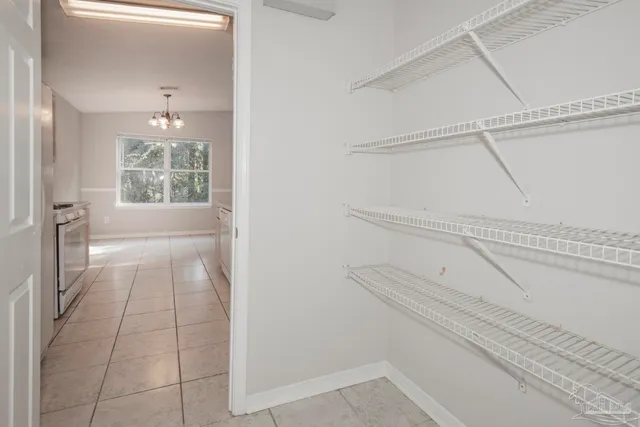 a kitchen with stainless steel appliances a white stove top oven and white cabinets