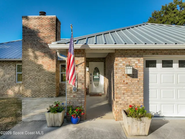 a kitchen with granite countertop a stove sink and refrigerator