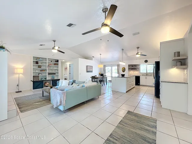 a large kitchen with a table and chairs