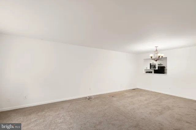 a view of a room with wooden floor and white walls