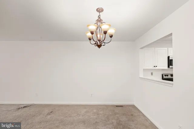a kitchen with a refrigerator a sink and dishwasher with wooden floor