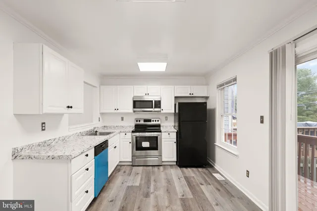 a view of bedroom with wooden floor and window