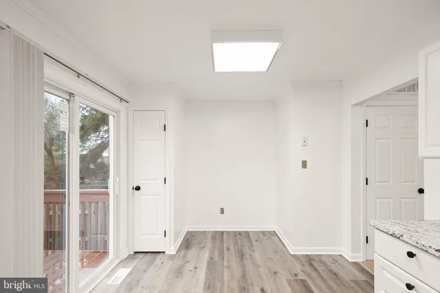 a kitchen with granite countertop white cabinets white stainless steel appliances and a sink