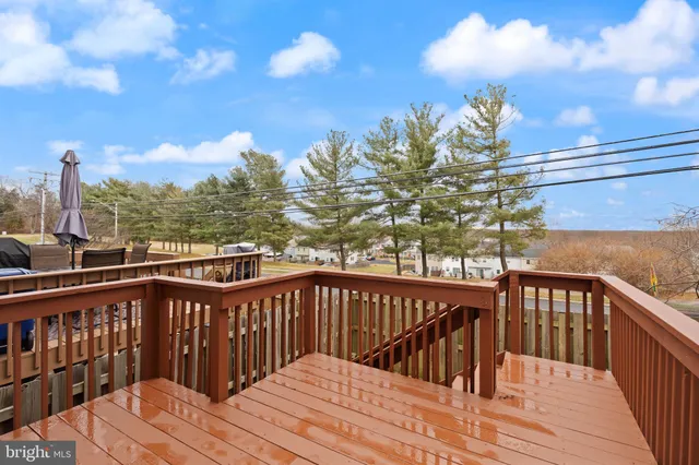 a view of a house with barbeque and wooden stairs