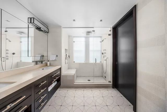 a spacious bathroom with a double vanity sink a mirror and a bathtub