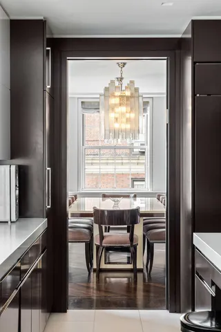 a view of a dining room with furniture and a window