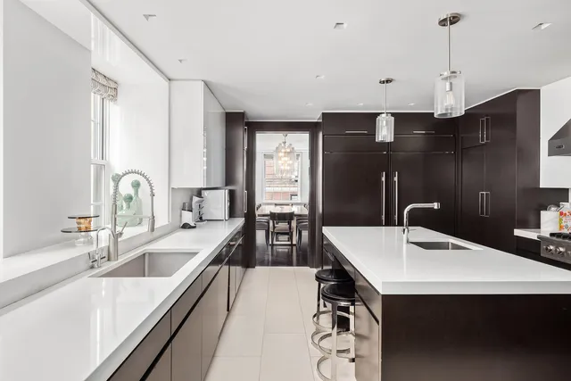 a kitchen with a sink a stove and chairs