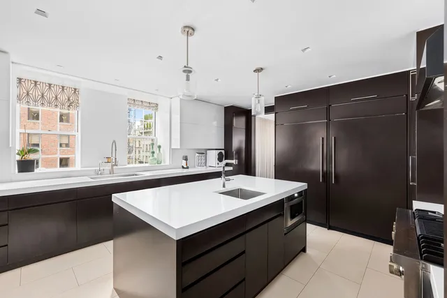 a kitchen with a sink refrigerator and window