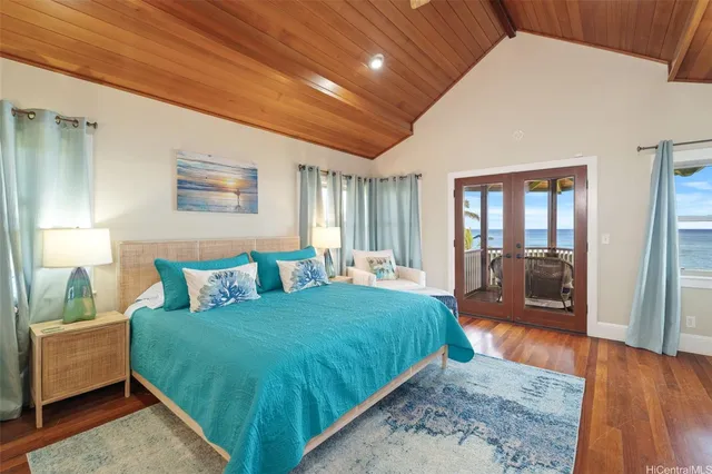 a spacious bedroom with a bed a mirror and a large window