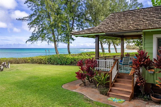 a view of a patio with a table chairs potted plants and a palm tree