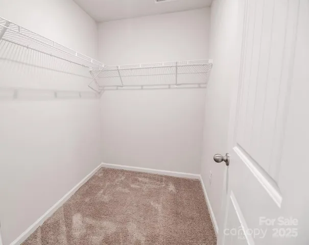 a bathroom with a granite countertop sink a toilet a mirror and shower