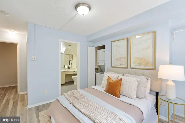 a bedroom with a bed and a lamp on table