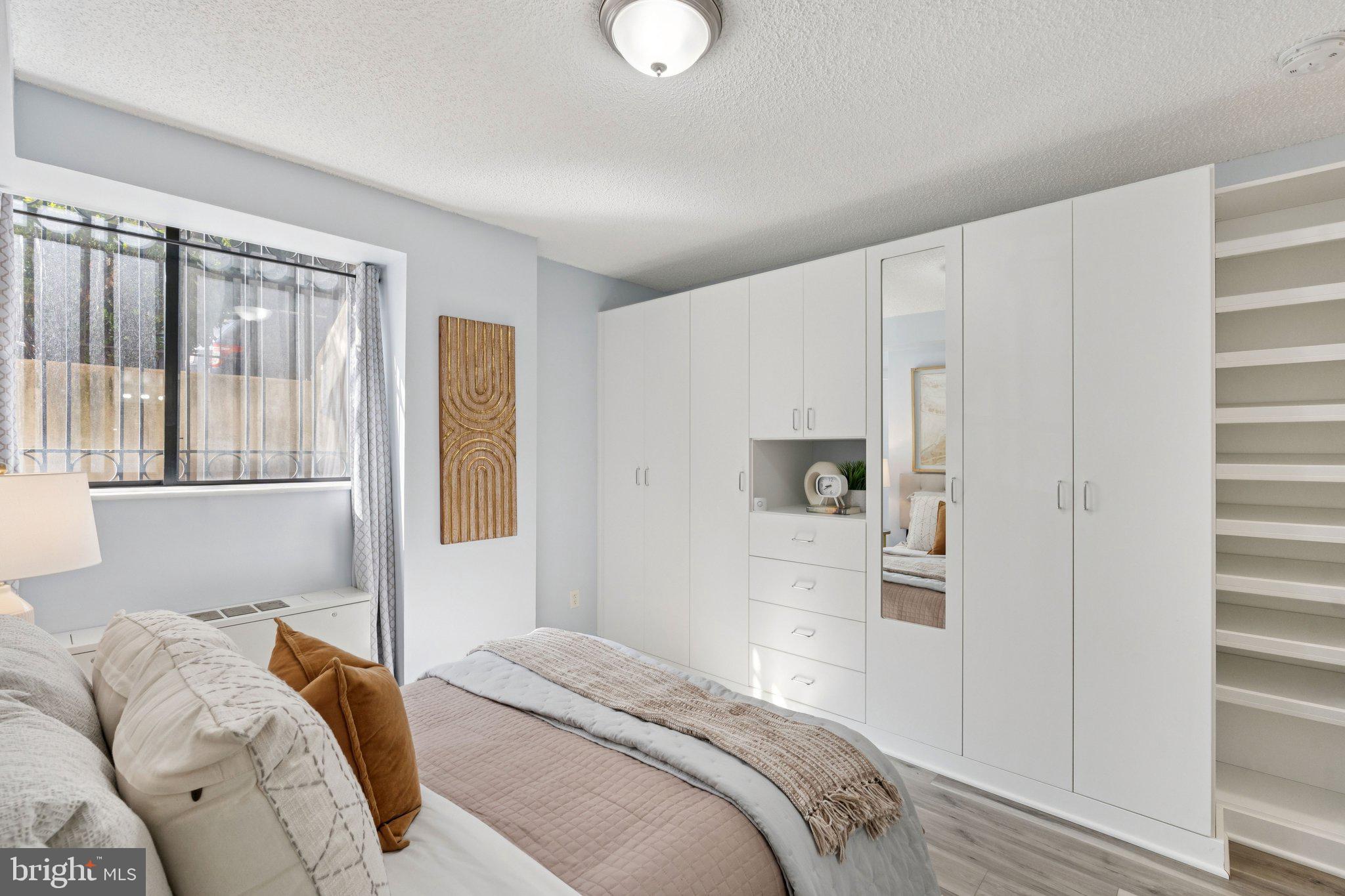 1245 13th Street Northwest, Unit 109 Washington, DC 20005 - Photo 15 of 25 a bedroom with a bed and a window