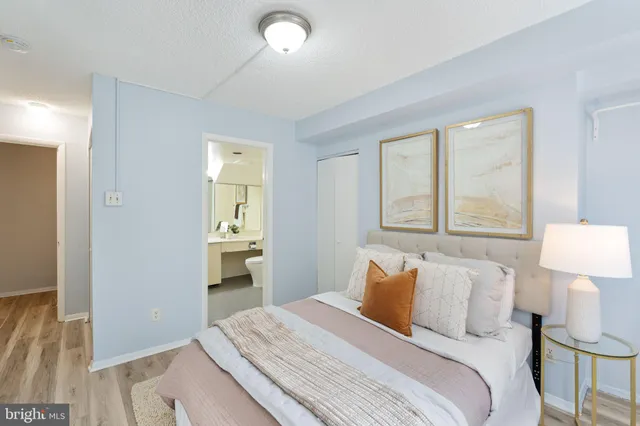 a bedroom with a bed and a lamp