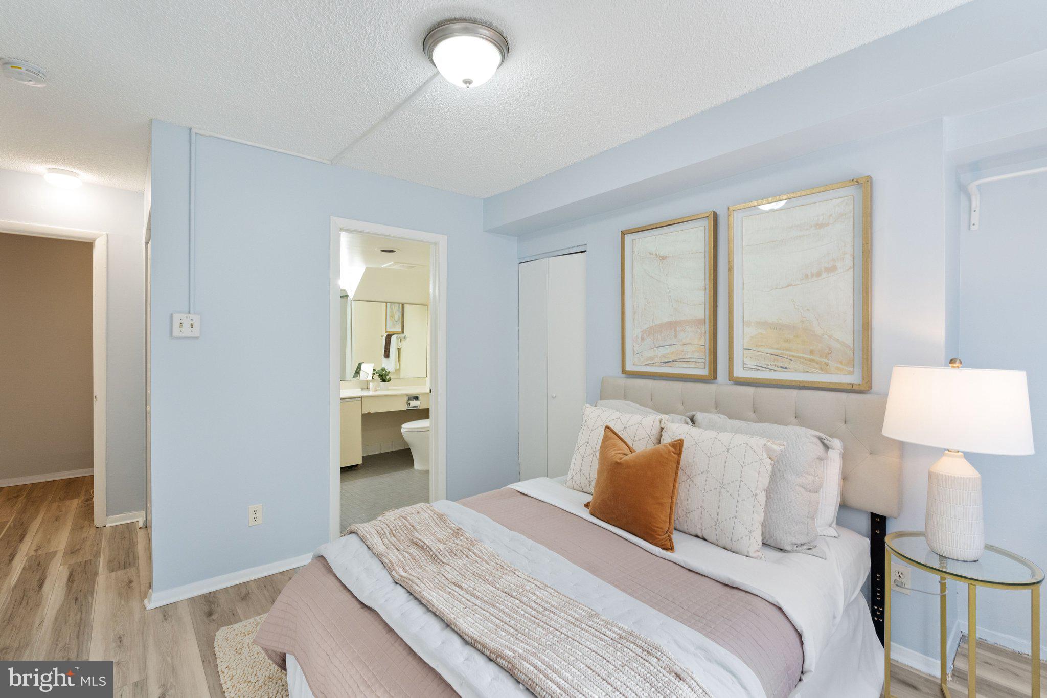 1245 13th Street Northwest, Unit 109 Washington, DC 20005 - Photo 16 of 25 a bedroom with a bed and a lamp