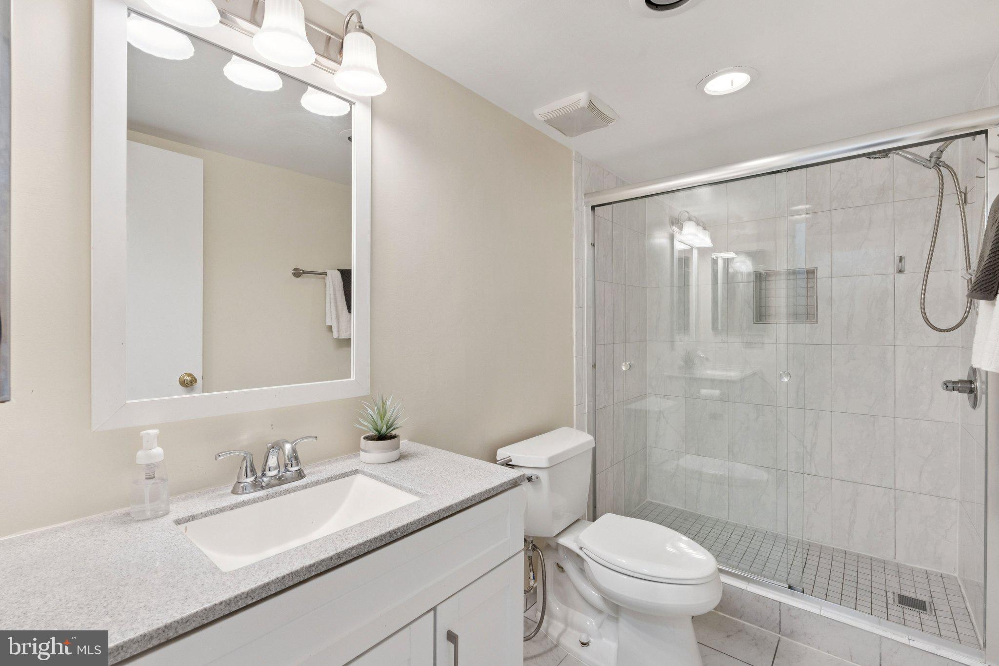 1245 13th Street Northwest, Unit 109 Washington, DC 20005 - Photo 21 of 25 a bathroom with a sink a toilet and shower