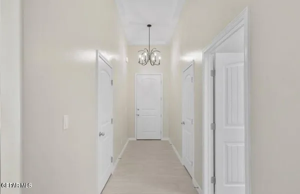 a view of a hallway with chandelier and entryway