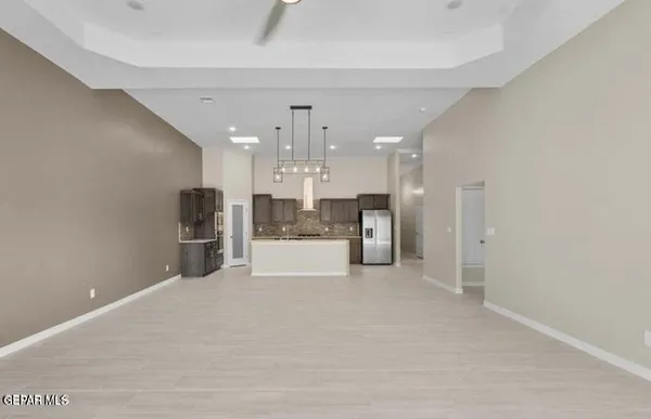 a view of kitchen with refrigerator and window