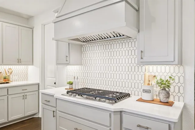 a stove top oven sitting inside of a kitchen
