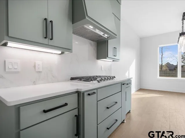 a kitchen with a stove and a refrigerator