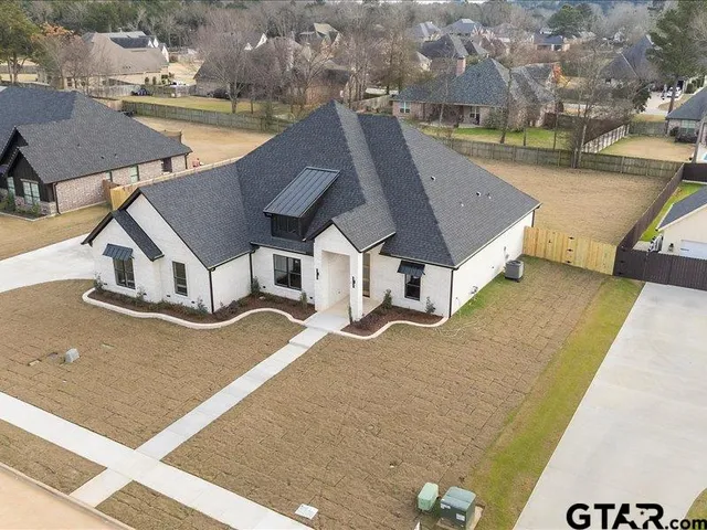an aerial view of a house with outdoor space