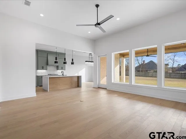 a view of a kitchen with a sink and a large window