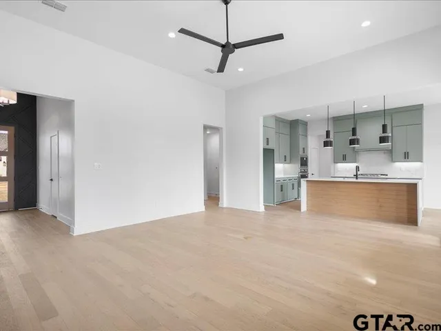 a view of a kitchen with a sink stainless steel appliances and cabinets