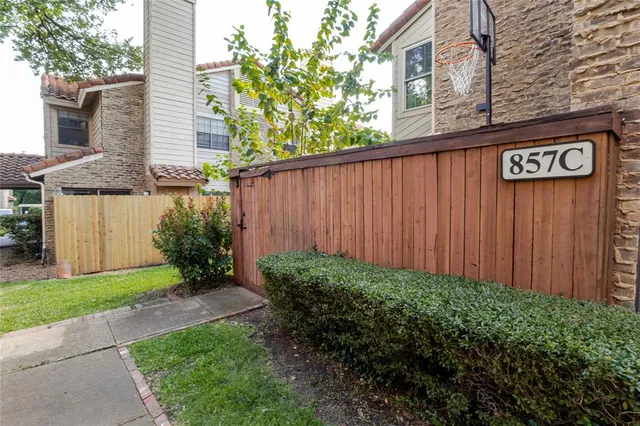 a view of a street with a wooden fence