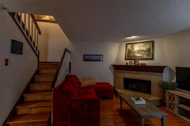 a living room with furniture fireplace and flat screen tv
