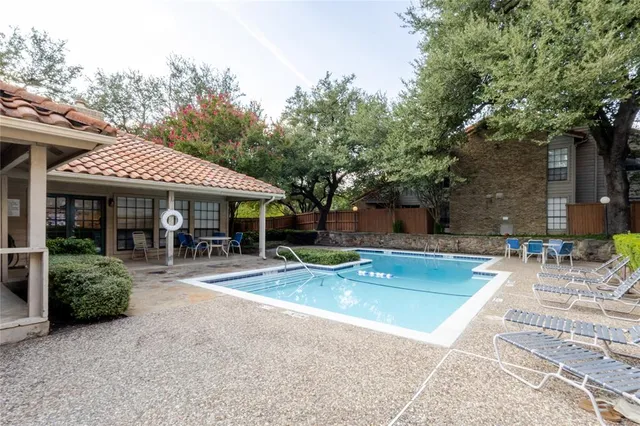 a view of a house with sitting area next to a yard