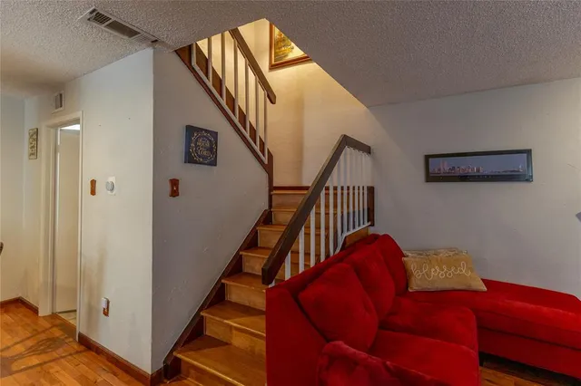 a living room with furniture and stairs