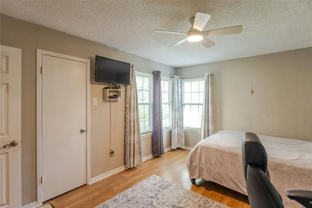 a bedroom with a bed and a large window